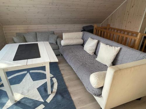 a living room with a couch and a table at 6 person holiday home in Rubbestadneset in Rubbestadneset