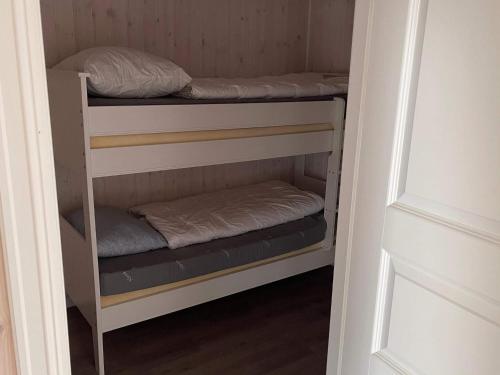 a closet with three bunk beds in it at 6 person holiday home in Rubbestadneset in Rubbestadneset