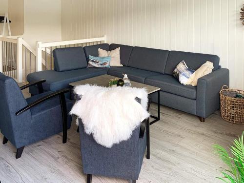 a living room with a couch and a table at 8 person holiday home in Urangsvåg in Ervik