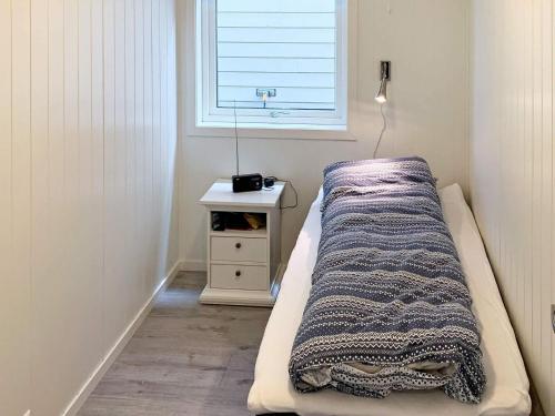 a bed in a room with a window at 8 person holiday home in Urangsvåg in Ervik