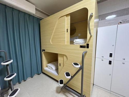 a small room with a bunk bed in it at Qing Youth Hostel in Guilin