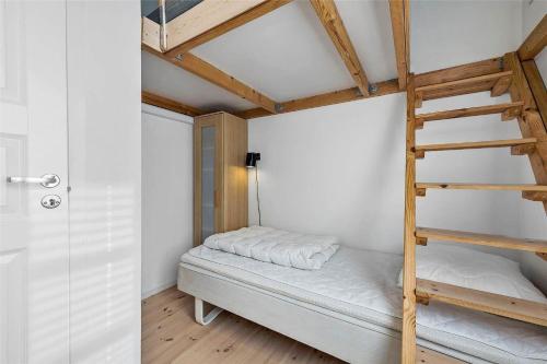 a bedroom with a bunk bed with a ladder at FY318-Nyborg-Sommerbyen-23 in Nyborg