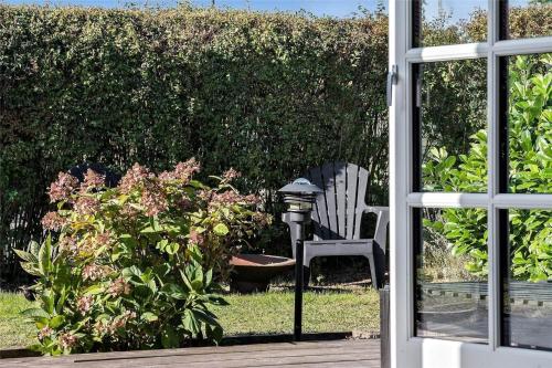 a porch with a bench and a lamp and a bush at FY318-Nyborg-Sommerbyen-23 in Nyborg