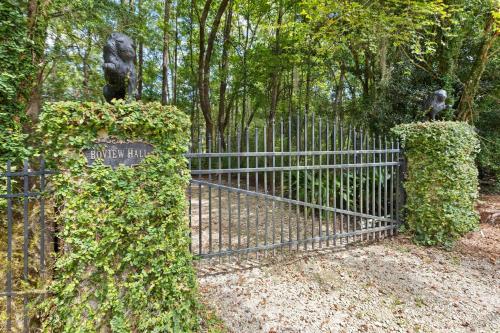 a metal gate with ivy on it in a park at Boview Hall- Poo l Hot Tub-15 mins to Kiawah in Johns Island