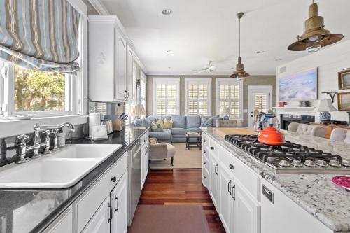 a kitchen with a sink and a stove top oven at Boview Hall- Poo l Hot Tub-15 mins to Kiawah in Johns Island
