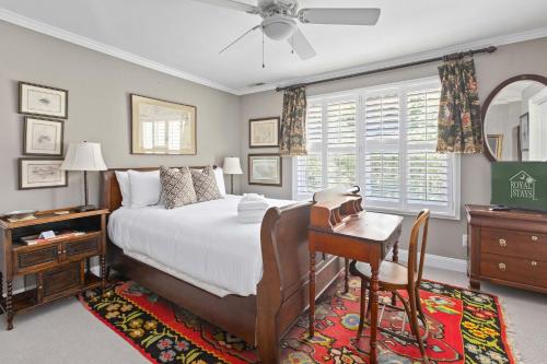 a bedroom with a bed and a desk and a table at Boview Hall- Poo l Hot Tub-15 mins to Kiawah in Johns Island