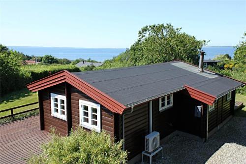 a small cabin with a roof on a deck at LF21543-Spottrup-Tyttebaervej-10 in Lem