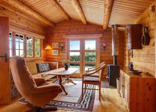 a living room with a table in a log cabin at LF21543-Spottrup-Tyttebaervej-10 in Lem