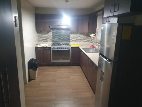 an empty kitchen with a stove and a refrigerator at Casa paseo cumbres in Monterrey