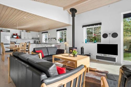 a living room with a couch and a table at LF14198-Roslev-Bagvejen-2 in Roslev