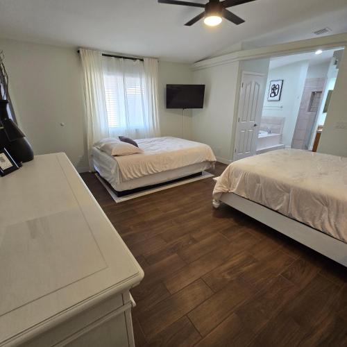 a bedroom with two beds and a flat screen tv at The Fieldhouse in Blythe