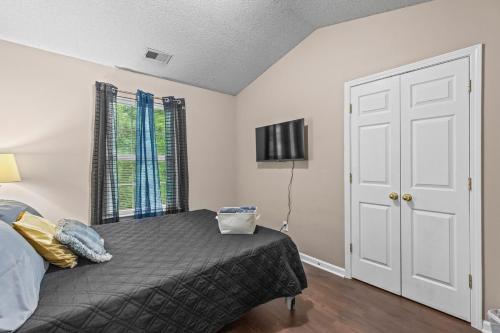 a bedroom with a bed and a window and a door at Spectacular Quiet Townhome with Modern Comfort in Stockbridge