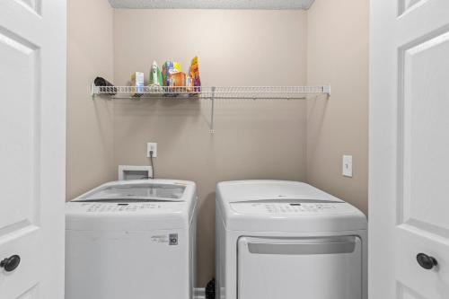 a small laundry room with a washer and dryer at Spectacular Quiet Townhome with Modern Comfort in Stockbridge