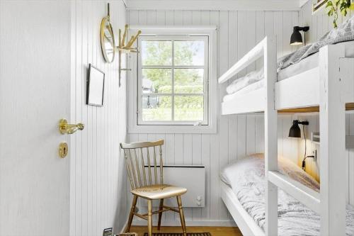 a childs bedroom with bunk beds and a chair at LF622-Hurup-Bakkesiden-22 in Hurup