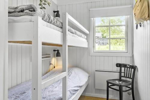 a bedroom with two bunk beds and a window at LF622-Hurup-Bakkesiden-22 in Hurup