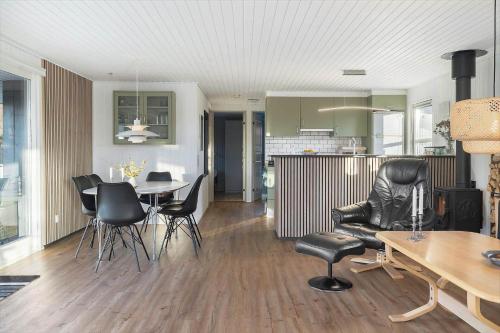 a living room with a table and chairs and a kitchen at LF11731-Struer-Skraningen-31 in Struer