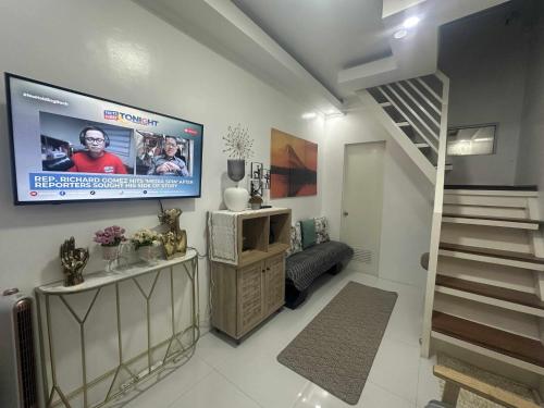 a living room with a flat screen tv on the wall at MisyEdz Homes Dau Good for 2 near Clark, SNR,Malls, Airport in Mabalacat