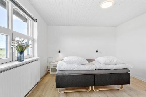 a bedroom with a bed in a room with a window at LF14145-Spottrup-Uglkaeret-5 in Spottrup