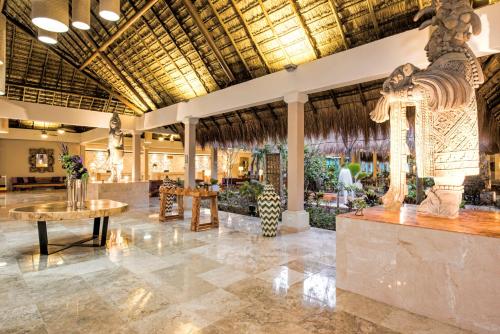 a lobby of a resort with a large building at Iberostar Waves Tucán in Playa del Carmen