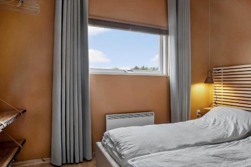 a bedroom with a bed and a window at LF13025-Oster-Assels-Kanalstien-3 in Øster Assels