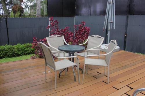 a group of chairs and a table on a deck at Diyar Villas Puncak M3/47 in Puncak