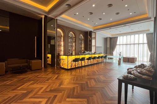 a lobby with a table and a bar in a building at Asialink Hotel Batam by Prasanthi in Nagoya