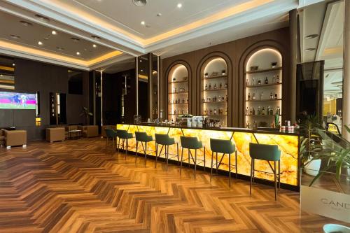 a bar in a restaurant with chairs around it at Asialink Hotel Batam by Prasanthi in Nagoya