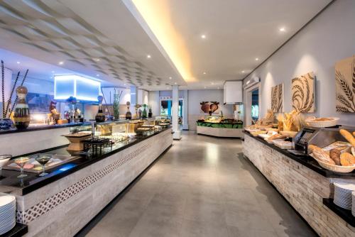 a restaurant with a buffet line with food on display at Iberostar Waves Tucan - All Inclusive in Playa del Carmen