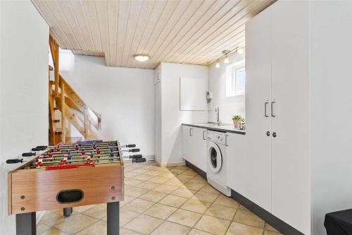 a kitchen with a table and a washing machine at LF483-Snedsted-Bjergvej-8 in Snedsted