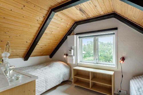 a bedroom with a bed and a sink and a window at LF14160-Roslev-Pinen-52 in Roslev