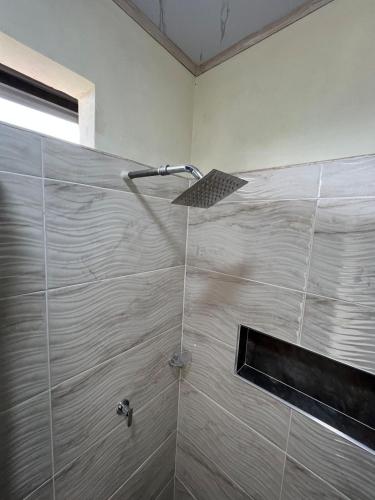 a shower with a shower head in a bathroom at Romantic Glamping - Vista Impresionante Villeta Jacuzzi in Villeta