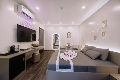 a living room with a bed and a table at Catba SunWoo Homestay & Hotel in Cat Ba