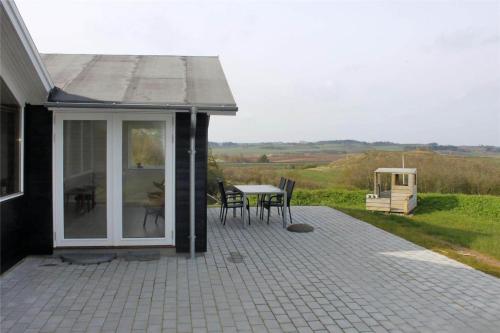 a patio with a table and chairs on a house at LF11932-Struer-Gl-Landevej-23 in Struer