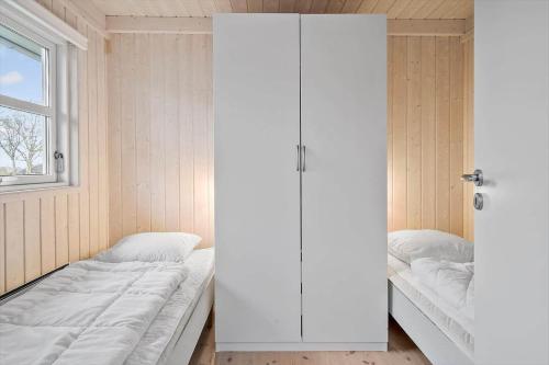 a bedroom with a bed and a window and a door at LF666-Hurup-Thy-Bakkesiden-5 in Doverodde