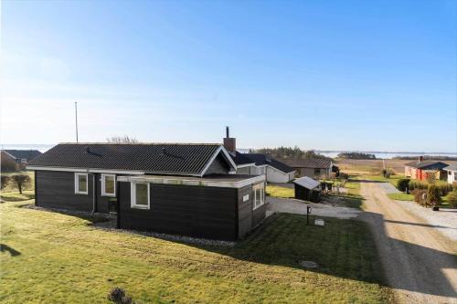 a small house in a field next to a road at LF888-Snedsted-Over-Reese-5 in Snedsted