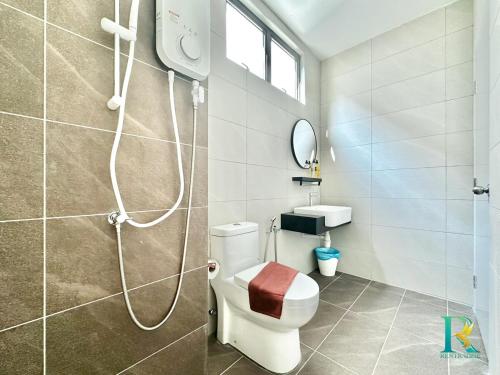 a bathroom with a shower and a toilet and a sink at Optimus Medini By RR JBcity in Iskandar Puteri