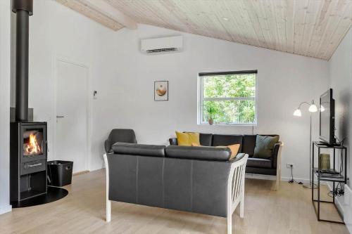 a living room with a couch and a fireplace at LF143-Vestervig-Gunhildsvej-43 in Vestervig