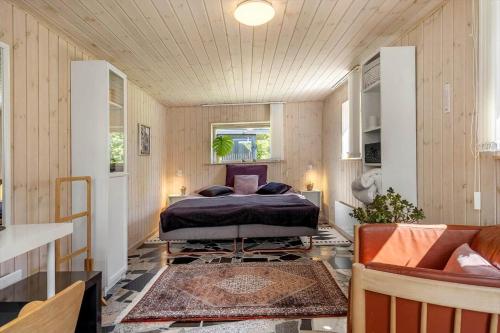 a bedroom with a bed in the middle of a room at LF10004-Thyholm-Agertoften-4 in Thyholm