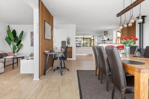 a dining room and living room with a table and chairs at LF13171-Nykobing-M-Fjordvej-34 in Nykøbing Mors
