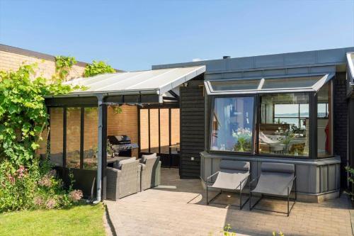 a black greenhouse with two chairs and a table at LF13171-Nykobing-M-Fjordvej-34 in Nykøbing Mors