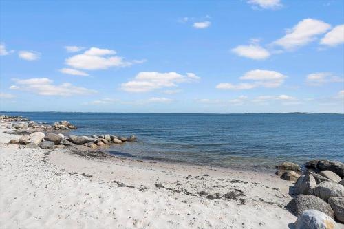 a beach with a bunch of rocks and the water at LF13171-Nykobing-M-Fjordvej-34 in Nykøbing Mors