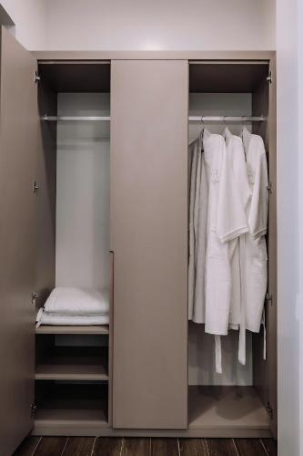 a walk in closet with white clothes at Catba SunWoo Homestay & Hotel in Cat Ba