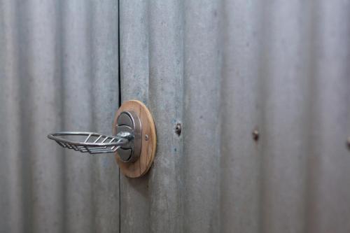 a wooden door with a door knocker on a wall at Funky Fish Beach & Surf Resort in Malolo