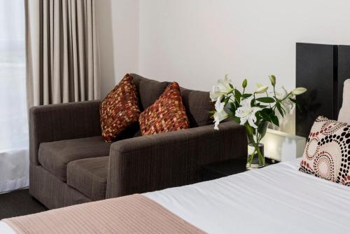 a living room filled with furniture and a couch at Oaks Ipswich Aspire Suites in Ipswich