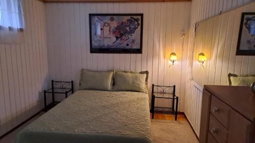 a bedroom with a bed with two night stands and two lamps at Garsoniera in Leirvåg
