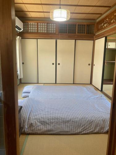 a bedroom with two beds in a boat at お宿とごはん百々 in Tanabe