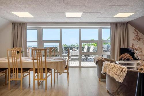 a dining room with a table and chairs with a view at LF10301-Hurup-Thy-Sindrupvej-1-B in Sindrup