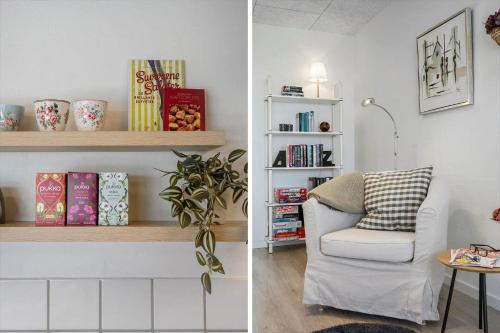 a living room with a chair and a shelf with books at LF10301-Hurup-Thy-Sindrupvej-1-B in Sindrup
