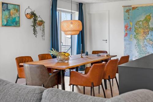 a dining room with a wooden table and chairs at LF12257-Hjerm-Livbjerggardvej-57 in Hjerm