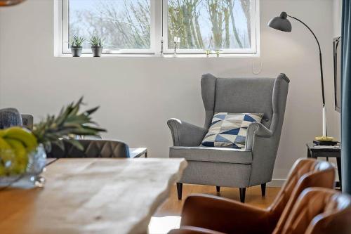 a living room with a table and a chair at LF12257-Hjerm-Livbjerggardvej-57 in Hjerm